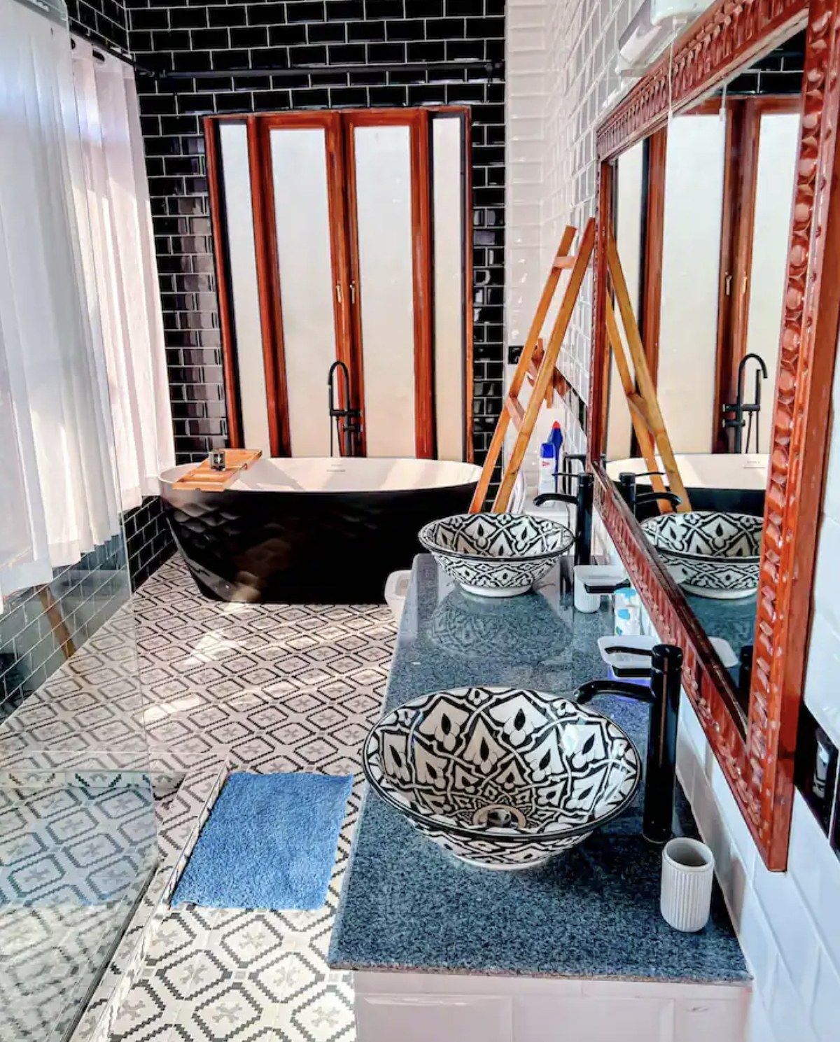 Bathroom with bathtub and twin basins